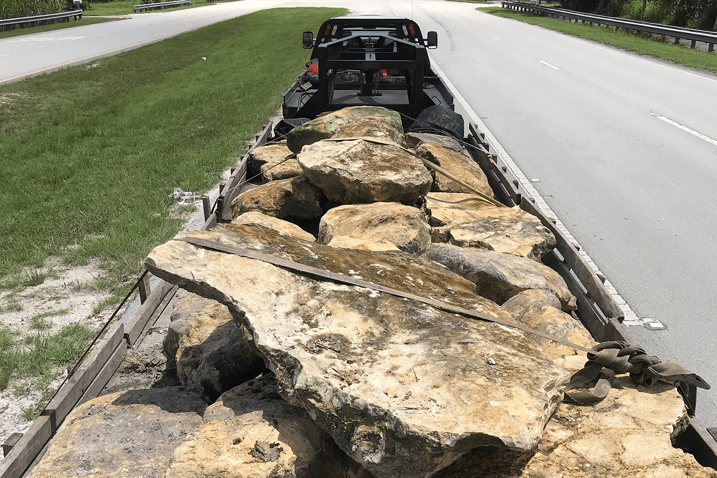 Pickup truck hauling a trailer of limestone rock