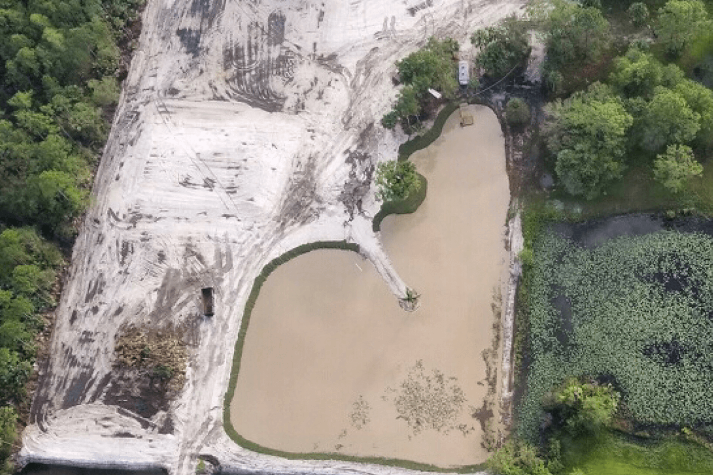 Aerial picture of graded land and a pond